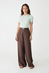 Catherine Short Sleeve Knit in jade, front view worn with brown wide-leg trousers