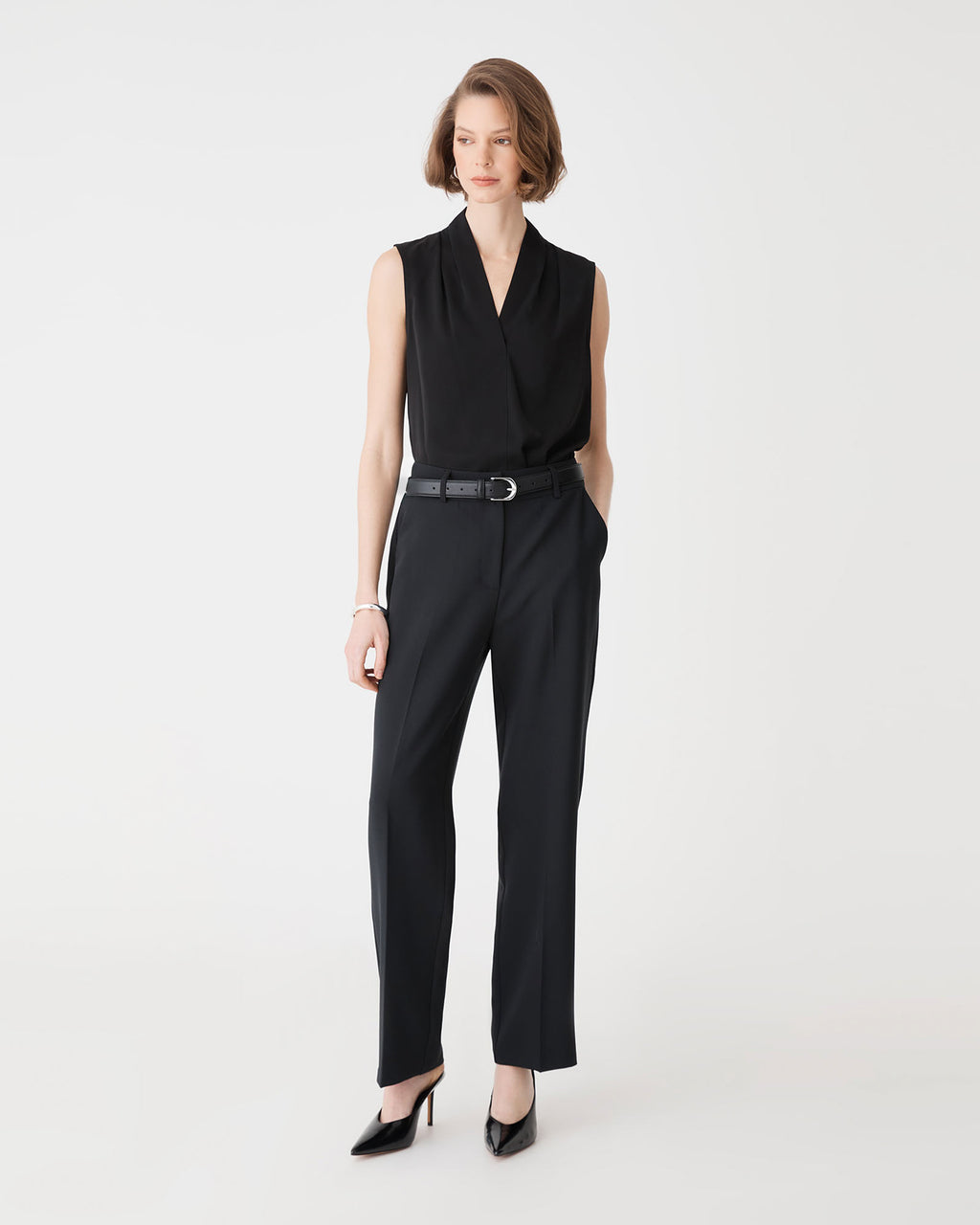 Alivia 2 V-Neck Top in black, front view, tucked into black trousers with a belt