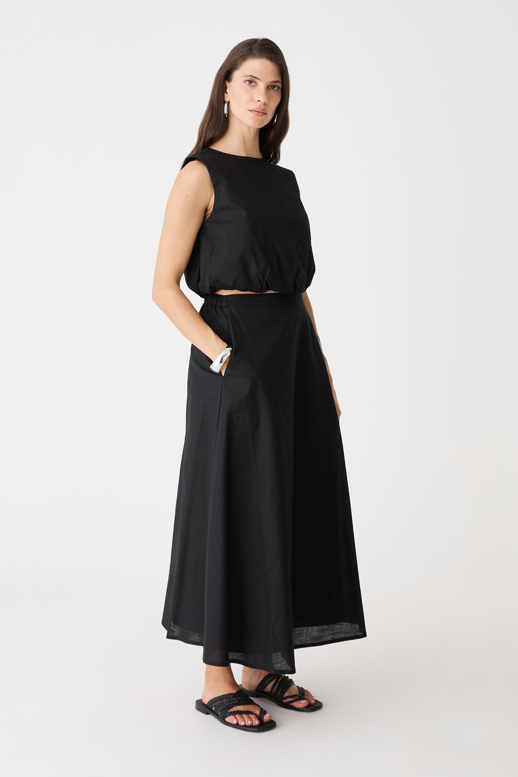 Side view of the black Kenya Linen Skirt showing midi length and A-line shape