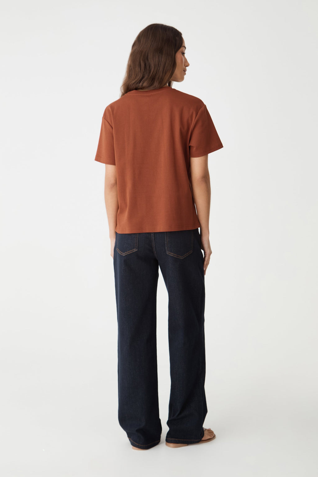Back view of the terracotta May Relaxed Cotton T-shirt with navy jeans