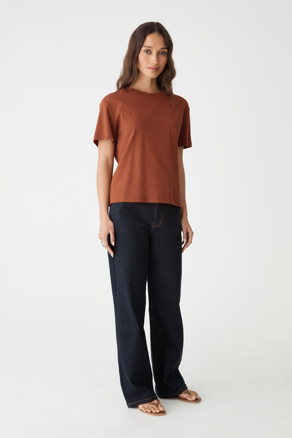Front view of the terracotta May Relaxed Cotton T-shirt, relaxed fit with navy trousers