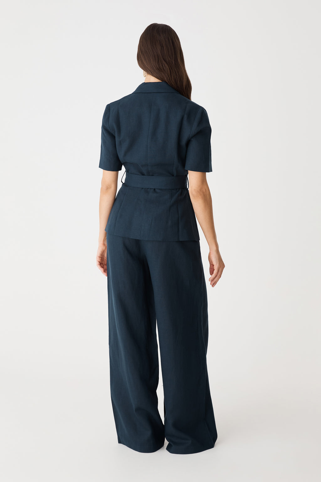Back view of the navy blazer with belt tie and matching wide-leg trousers