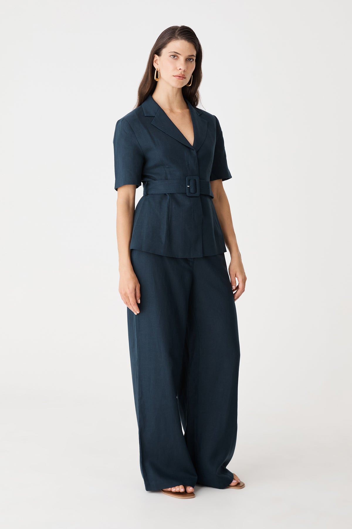 Side front angle of the navy blazer and matching trousers