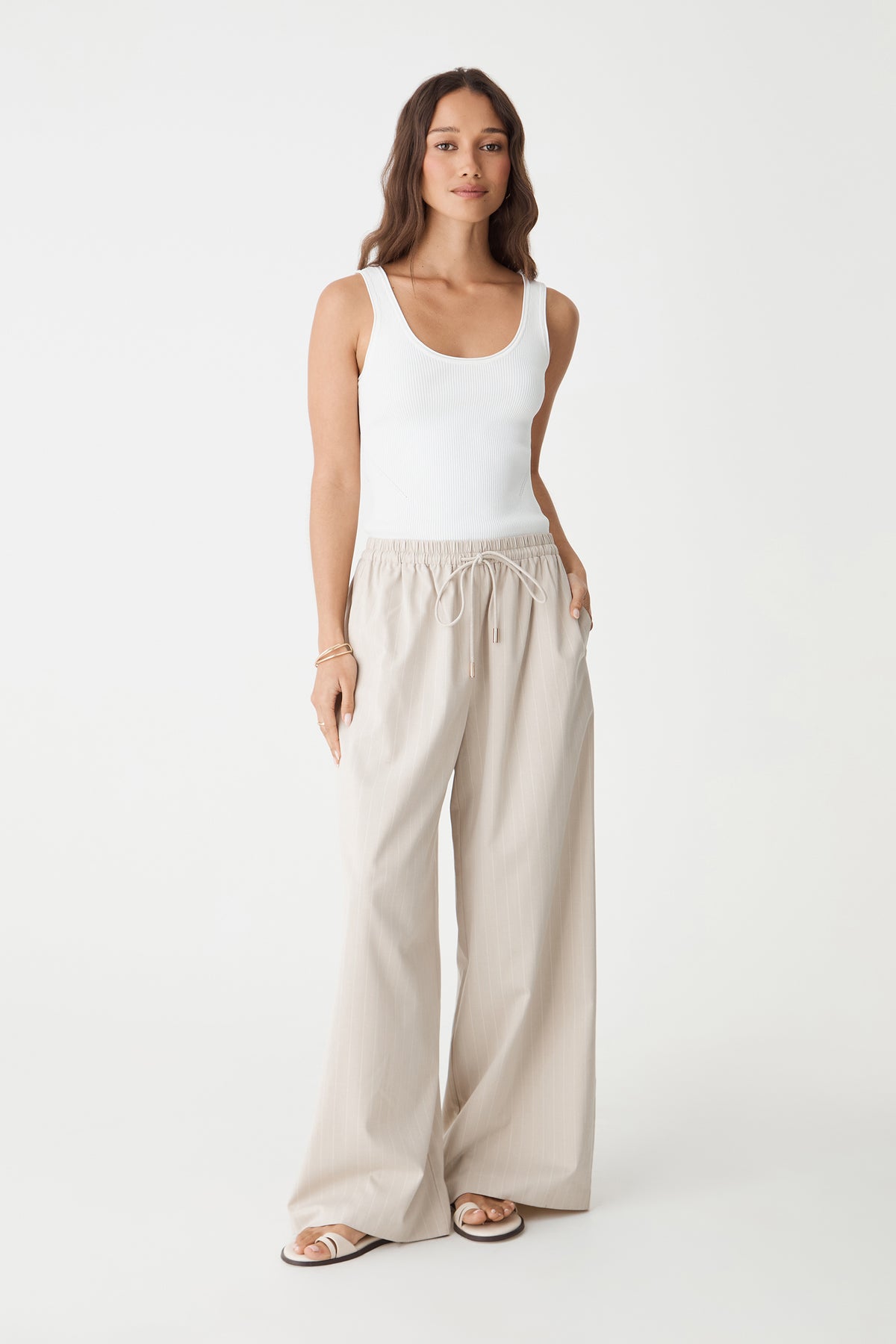 Zoe Elastic Pinstripe Pants in beige pinstripe, front view with white tank top