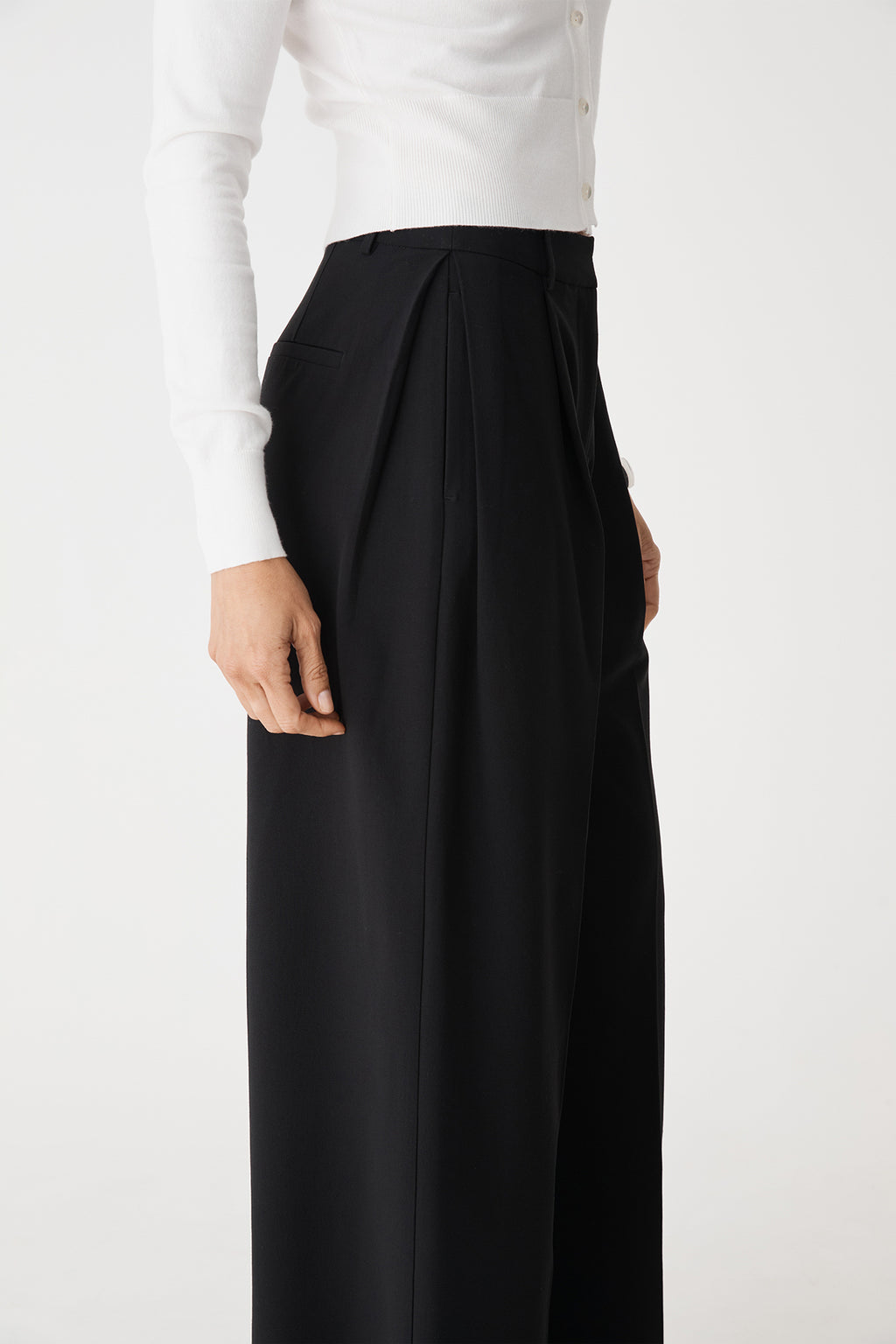 Side close-up of the front pleats and high waistband
