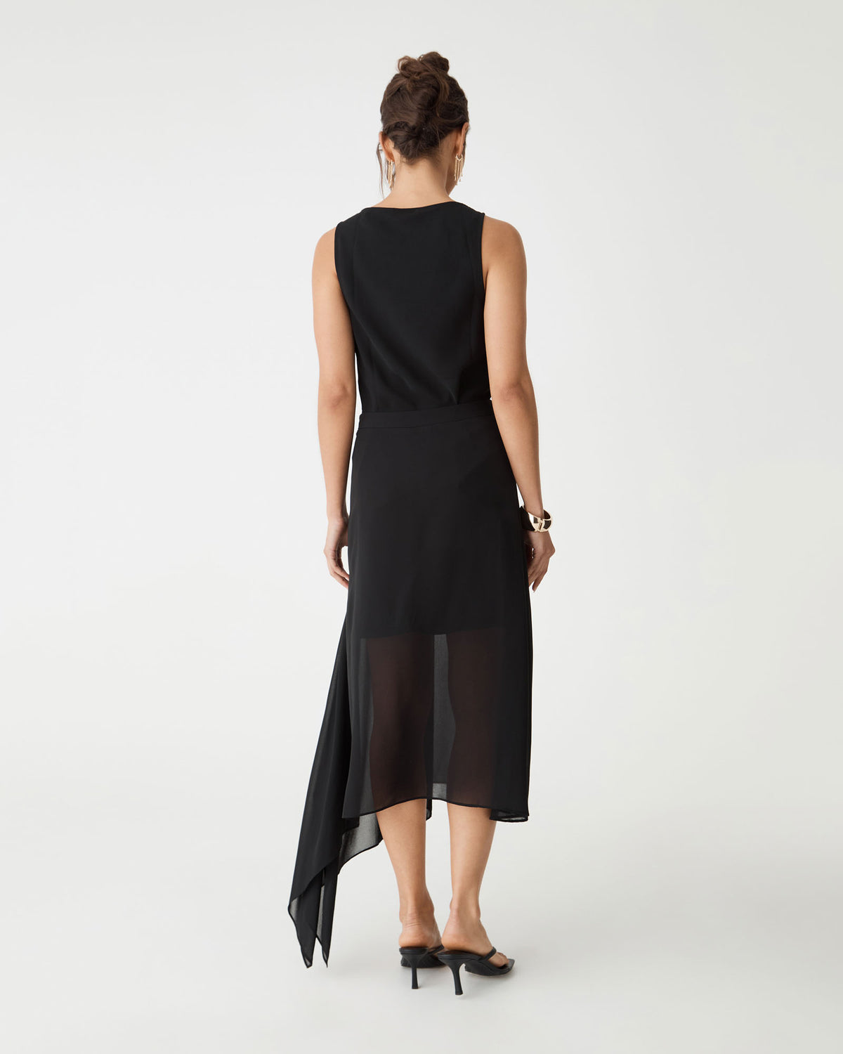Back view of the black skirt showing the asymmetric hem falling to one side