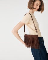 Tulum Fringe Bag in Chocolate Fondant worn crossbody at the hip, side view showing tiered front fringe