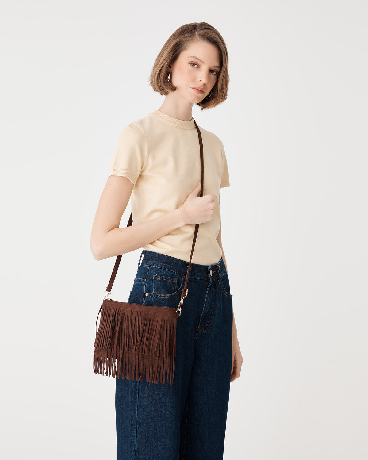 Front view of the Tulum Fringe Bag in Chocolate Fondant worn crossbody with adjustable strap