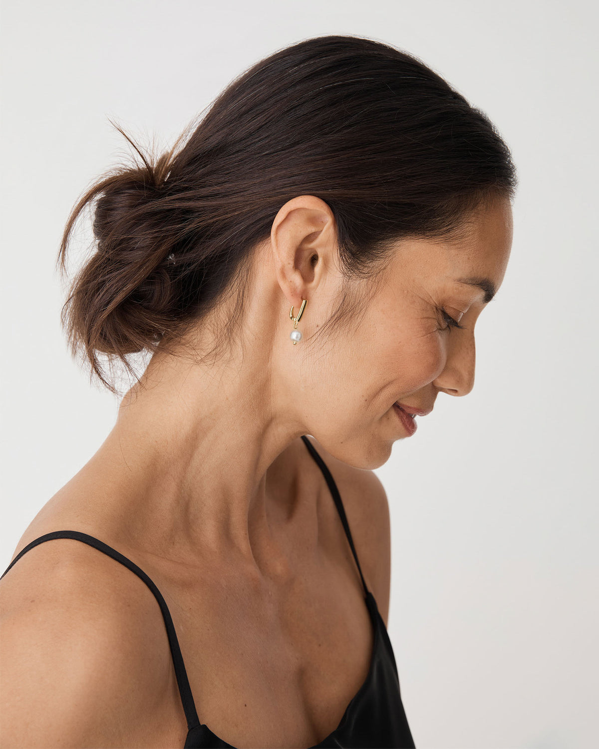 Mila Pearl Huggie Earrings in gold pearl — fabric detail 2